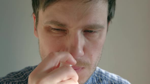 Man Splashes a Medicine in Runny Nose