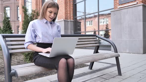 Woman Celebrating Success While Outdoor Working on Laptop