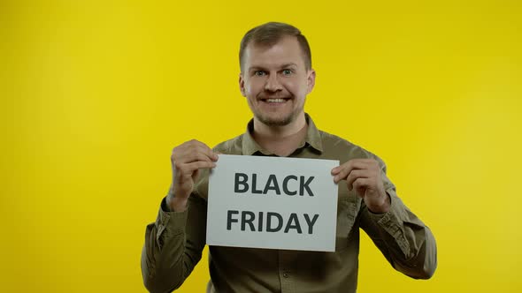 Man Smiling and Showing Black Friday Inscription, Rejoicing Discounts, Online Shopping Sales