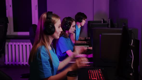 Online Gaming Three Friends Losing the Game in Computer Club Takes Off Their Headphones and Talking