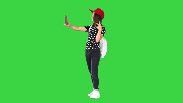 Asian School Girl Taking Selfie on a Green Screen, Chroma Key.