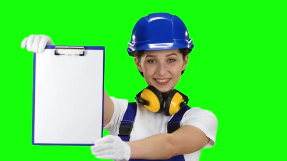 Engineer Picks Up the Paper Plate and Smiles. Green Screen. Close Up