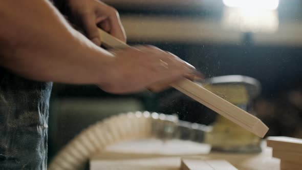 Joiner Grinds Wood By Hand with Sandpaper on the Table