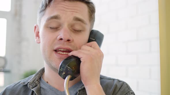 Close Up Happy Man in Talking and Screaming and Singign on Phone in Yellow Telephone Booth