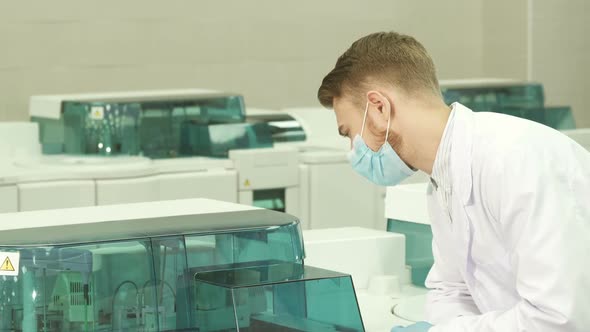 Serious Lab Technician Has Started a Laboratory Centrifuge