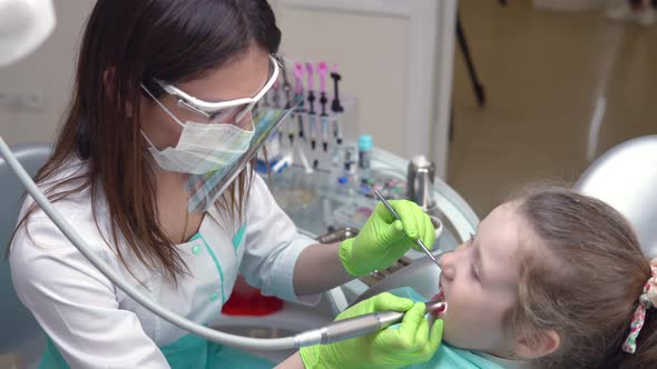 Dentist Cleans Girl's Teeth with Professional Toothpaste
