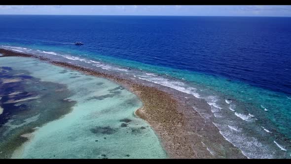 Aerial view sky of marine seashore beach time by blue water with white sandy background of a dayout 