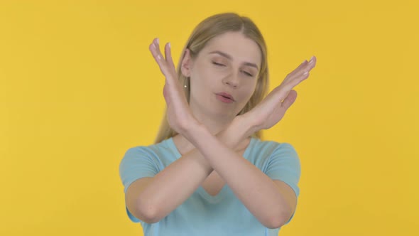 Rejecting Young Woman Denying on Yellow Background