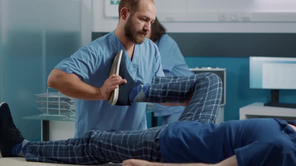 Health Therapist Cracking Legs Bones and Stretching Muscles