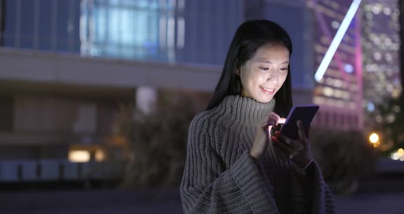 Woman Working on Smart Phone at Night