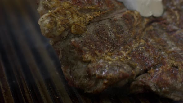 Turning Beef Steak on Grill