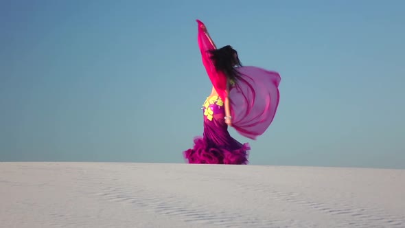 Girl with a Veil in Her Hands Dances a Belly Dance in the Desert. Slow Motion
