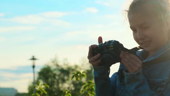 Portrait of a Little Girl Holding a Camera