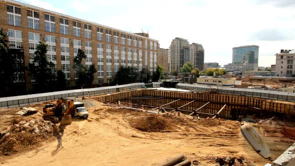 Timelapse of Excavators and Cranes Work at Construction Site alt