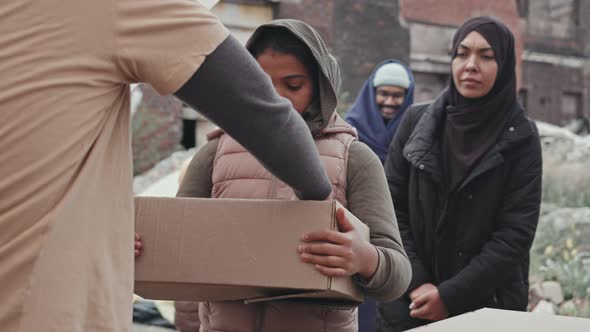 Refugee Girl Getting Donation Box with Water and Food