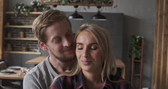 Enamored Husband and Wife Embracing Taking Care Support with Best Love Feeling at Luxury Apartment