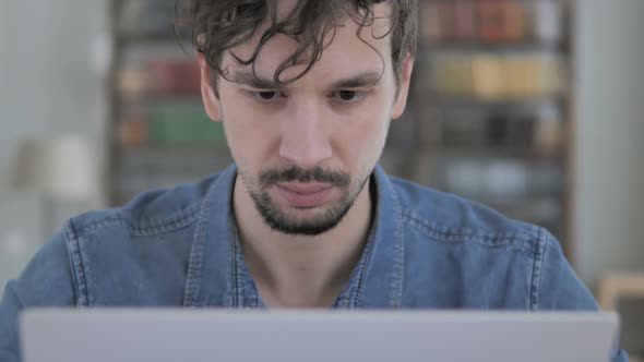 Smiling Casual Young Man at Work Looking in Camera