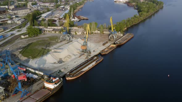 Port Cranes On A River Bank 