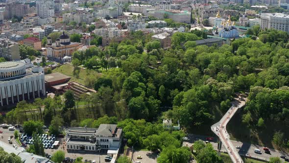 Summer flight in Kiev over the pedestrian bridge, tree crowns covered with green leaves.