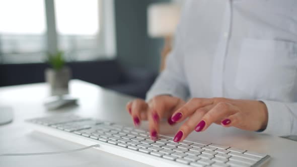 Woman Typing on a Computer Keyboard