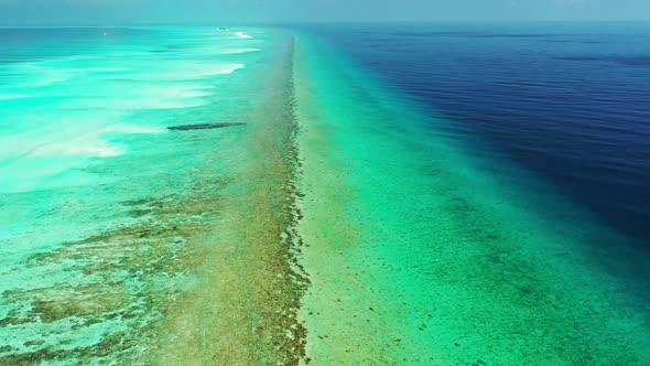 Aerial drone view panorama of tranquil coastline beach voyage by blue green sea with white sandy bac
