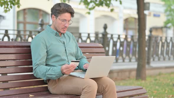 Man having Online Payment Decline on Laptop Outdoor