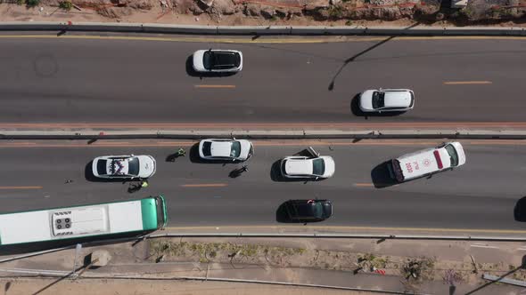 Ambulance making his way and arriving to a Car crash scene on a highway, Aerial follow footage.