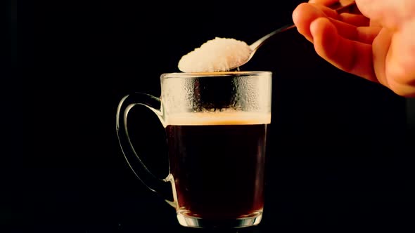 Adding Sugar In Coffee Cup. Pouring Sugar Into Coffee Or Tea In Slow Motion. Espresso With Sweetener