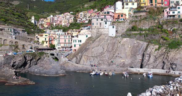 Colourful hamlet of Riomaggiore, Manarola with its scenic coastal setting; drone