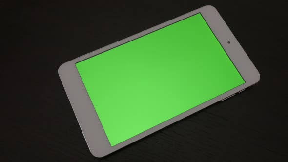 Silver green screen tablet  PC on dark wooden surface slow panning 4K 2160p UltraHD footage - Slow p