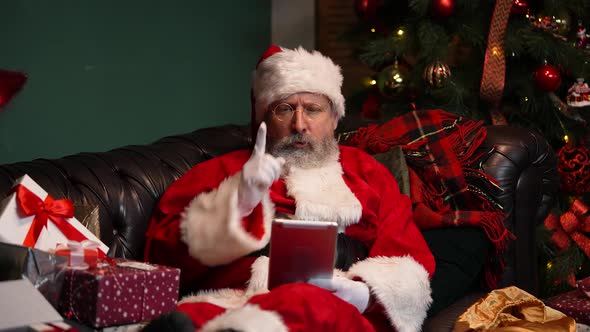 Santa Claus Communicates By Video Call Using Tablet
