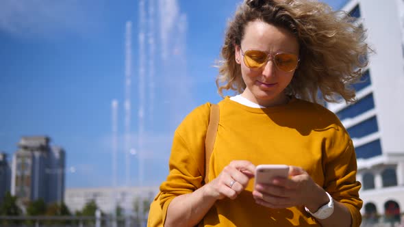 Young Woman Using Apps On Mobile Touchscreen Smartphone