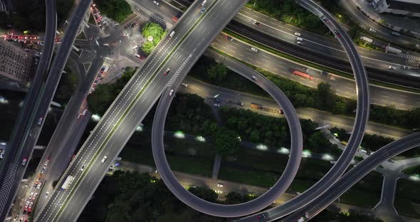 Aerial footage night view of modern city buildings with interchange overpass in shenzhen city,China