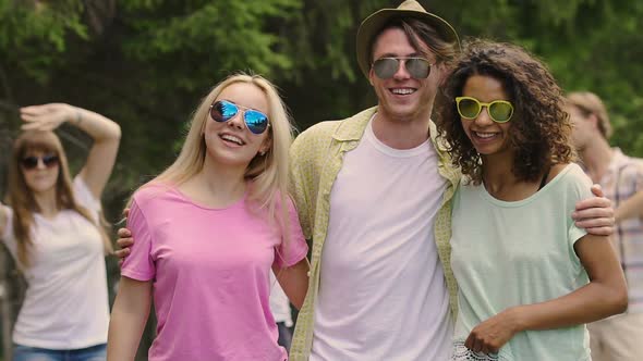 Happy Smiles on Faces of Cheerful Young People Dancing and Looking to Camera