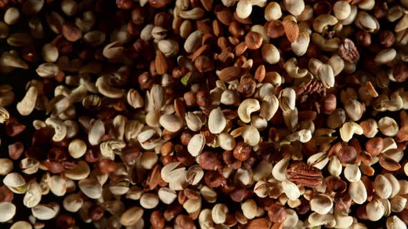 Super Slow Motion Shot of Flying Various Nuts Towards Camera Isolated on Black at 1000Fps