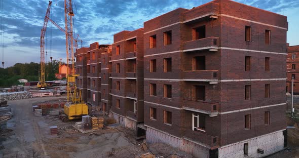 Construction site of low-rise brick houses in summer. Aerial view