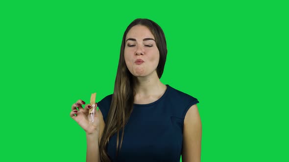 Sexy attractive girl eating a biscuit in front of a green screen