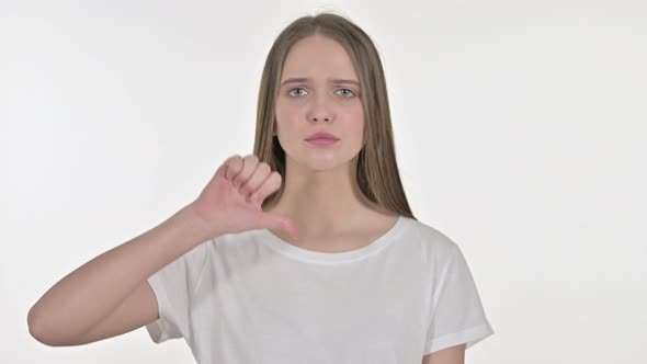 Thumbs Down By Beautiful Young Woman, White Background