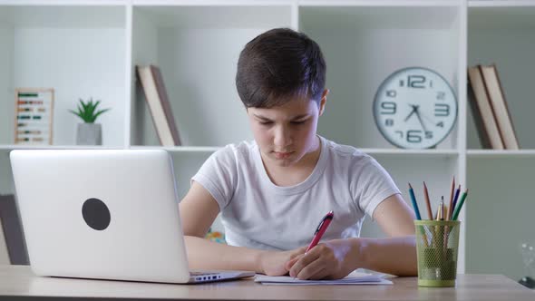 Pre Teen Handsome Boy Pupil Attending to Home Online School Class on His Computer Laptop Because of