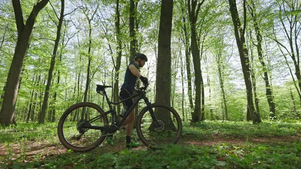 The Cyclist is Walking Next to the Bike