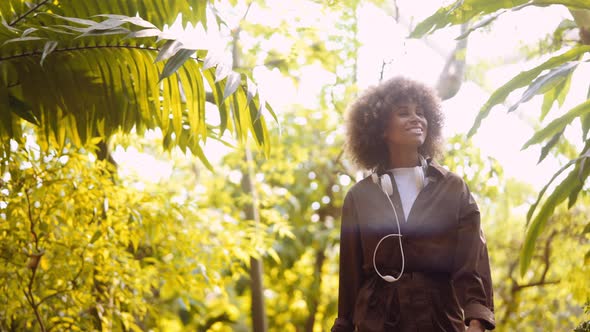 Young Woman Exploring Sunny Botanical Gardens