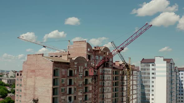 Aerial Drone View of Construction Cranes in Sunny Day. Construction Site Building in City alt