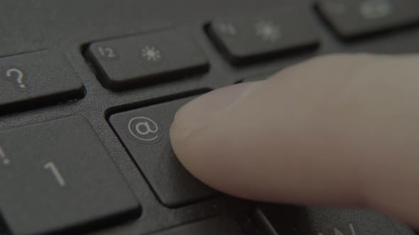 The Finger Presses a Button with a Number on the Keyboard