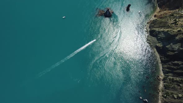 Aerial View From Above on Calm Azure Sea and Volcanic Rocky Shores