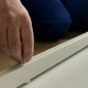 A Man a Handyman in a Blue Jumpsuit is Assembling a Table in Closeup - VideoHive Item for Sale
