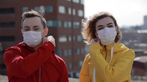 Virus Epidemic Is Finish in a City, Woman and Man Take Off Surgical Masks From Faces