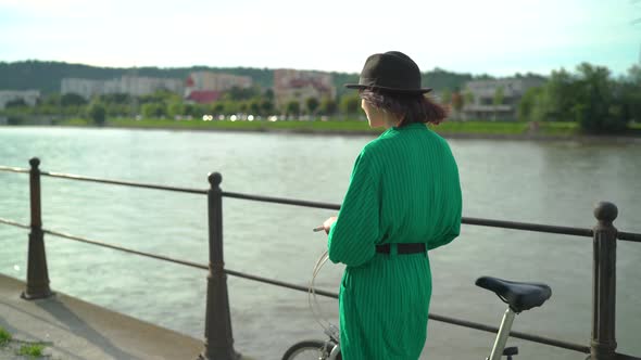 Walking along the waterfront with a bike