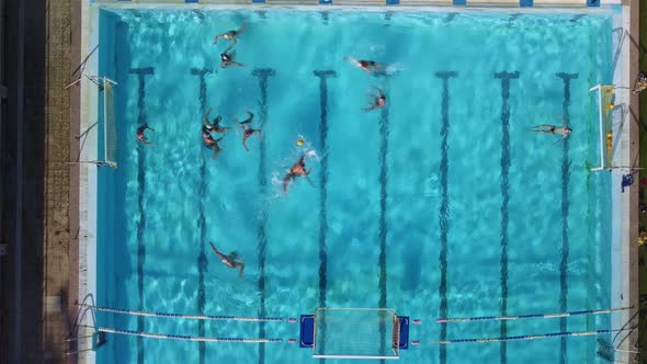 Aerial Drone Top View Shot of People Competing in Water Polo in Turquoise Water Pool