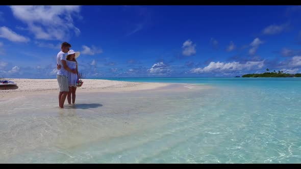 Teenage lovers tanning on luxury tourist beach wildlife by blue sea and white sandy background of th