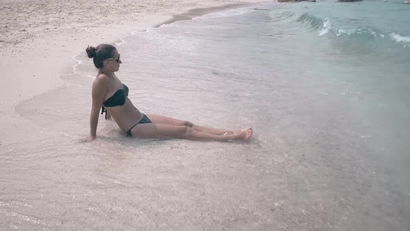 Waves Wash Woman with White Thick Foam and Water Splashes